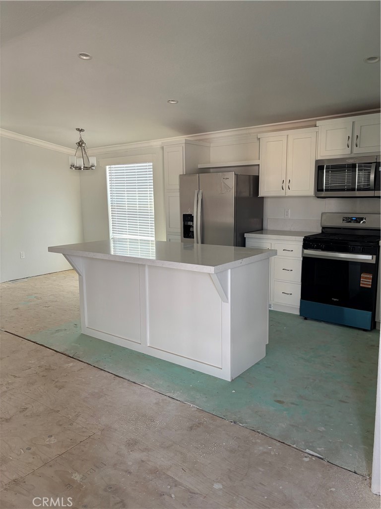 10550 Dunlap Crossing Road, Unit 27 Whittier, CA 90606 - Photo 6 of 13 a kitchen with stainless steel appliances a refrigerator sink and white cabinets