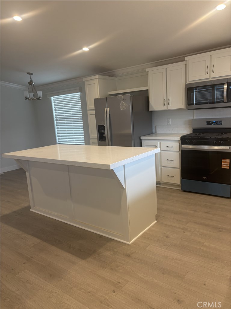 10550 Dunlap Crossing Road, Unit 27 Whittier, CA 90606 - Photo 6 of 14 a kitchen with granite countertop a stove and a sink