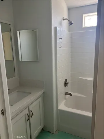 a bathroom with a sink a mirror and a bathtub