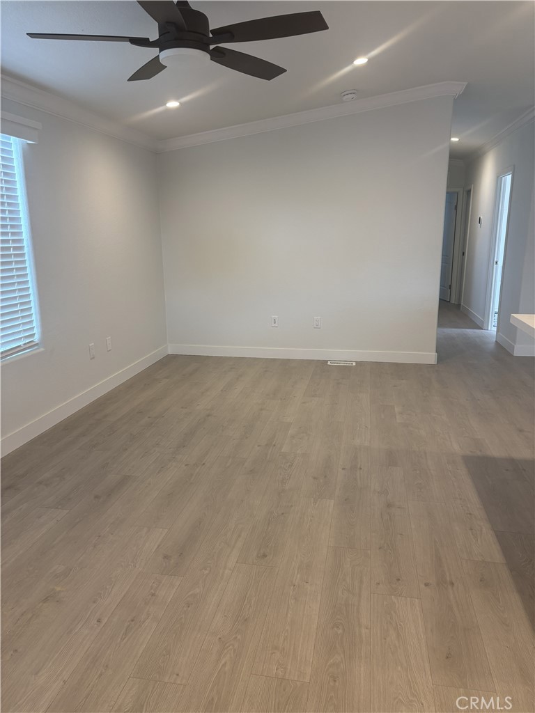 10550 Dunlap Crossing Road, Unit 27 Whittier, CA 90606 - Photo 7 of 14 an empty room with a ceiling fan and window