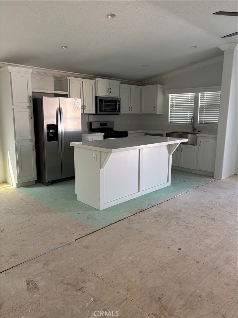 10550 Dunlap Crossing Road, Unit 27 Whittier, CA 90606 - Photo 7 of 13 a kitchen with stainless steel appliances a refrigerator a stove a sink a microwave and cabinets