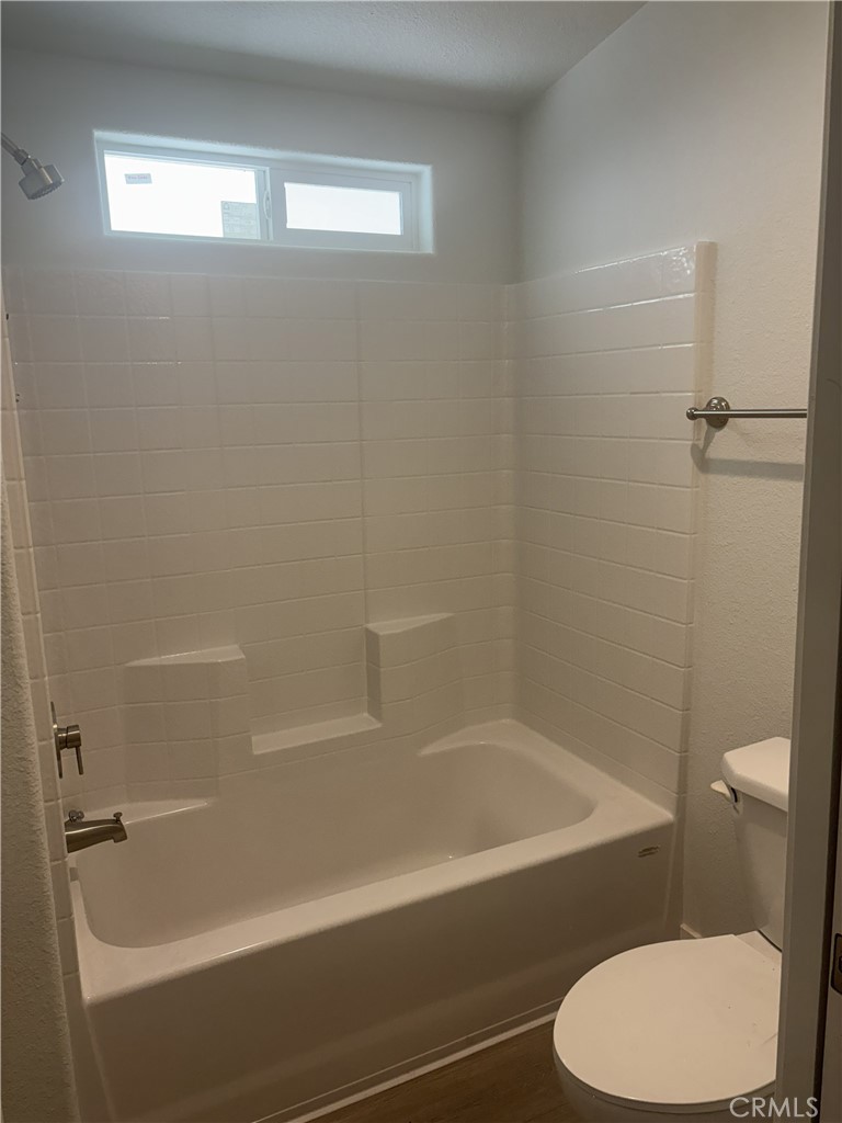 10550 Dunlap Crossing Road, Unit 27 Whittier, CA 90606 - Photo 9 of 14 a white bath tub sitting next to a toilet
