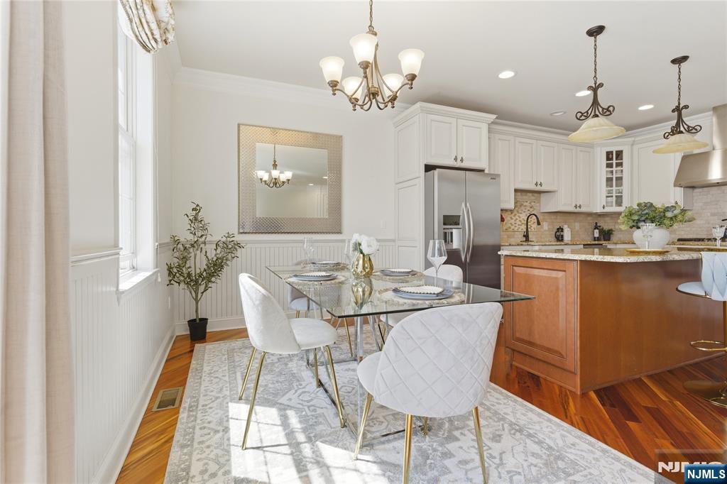 14 Gable Walk Livingston, NJ 07039 - Photo 15 of 41 a dining room with furniture a chandelier and wooden floor