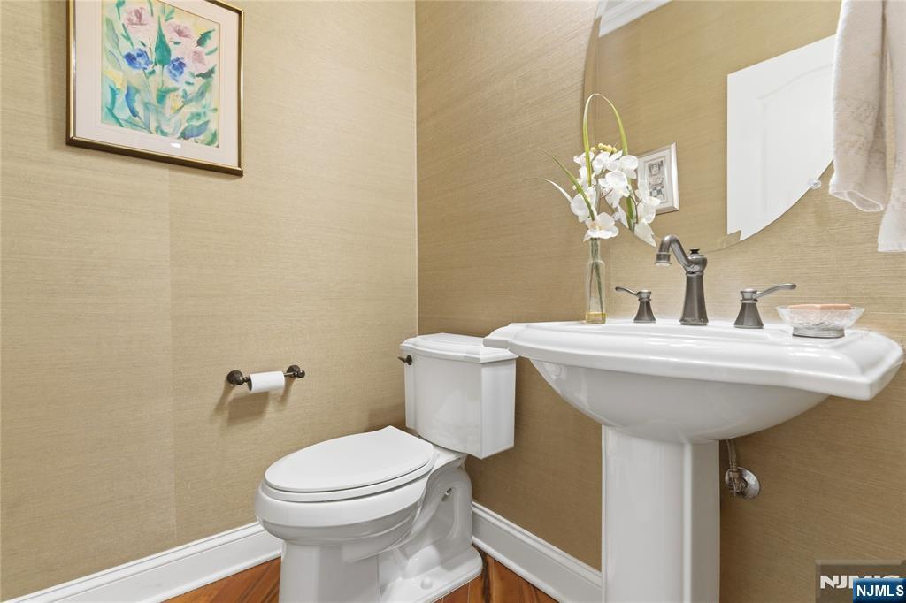 14 Gable Walk Livingston, NJ 07039 - Photo 20 of 41 a bathroom with a sink a toilet and mirror