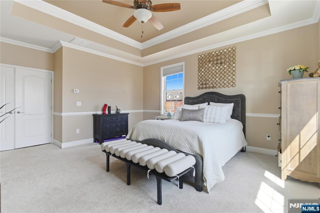 14 Gable Walk Livingston, NJ 07039 - Photo 23 of 41 a bedroom with a bed and a chandelier