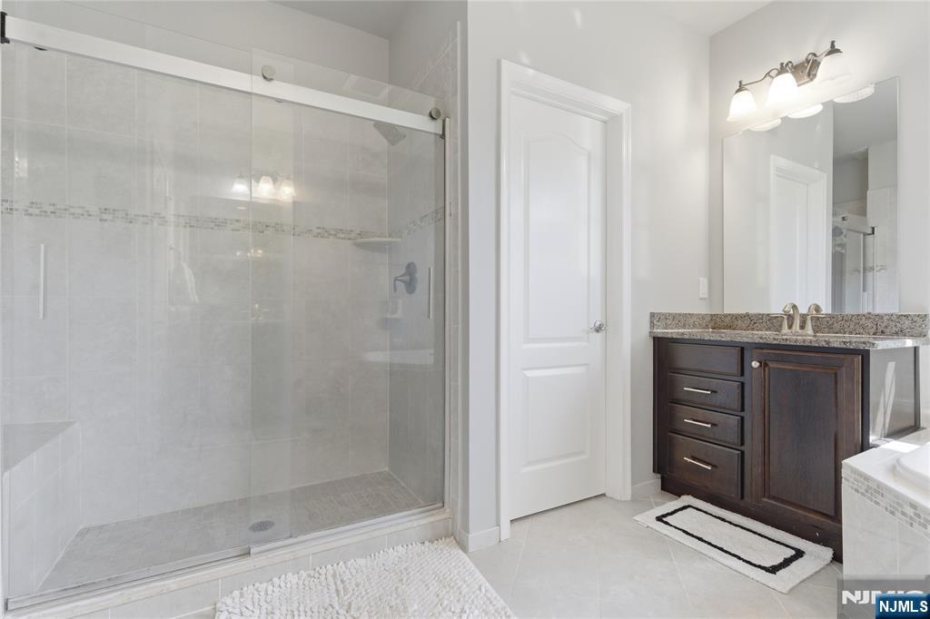 14 Gable Walk Livingston, NJ 07039 - Photo 26 of 41 a bathroom with a shower a sink and a mirror