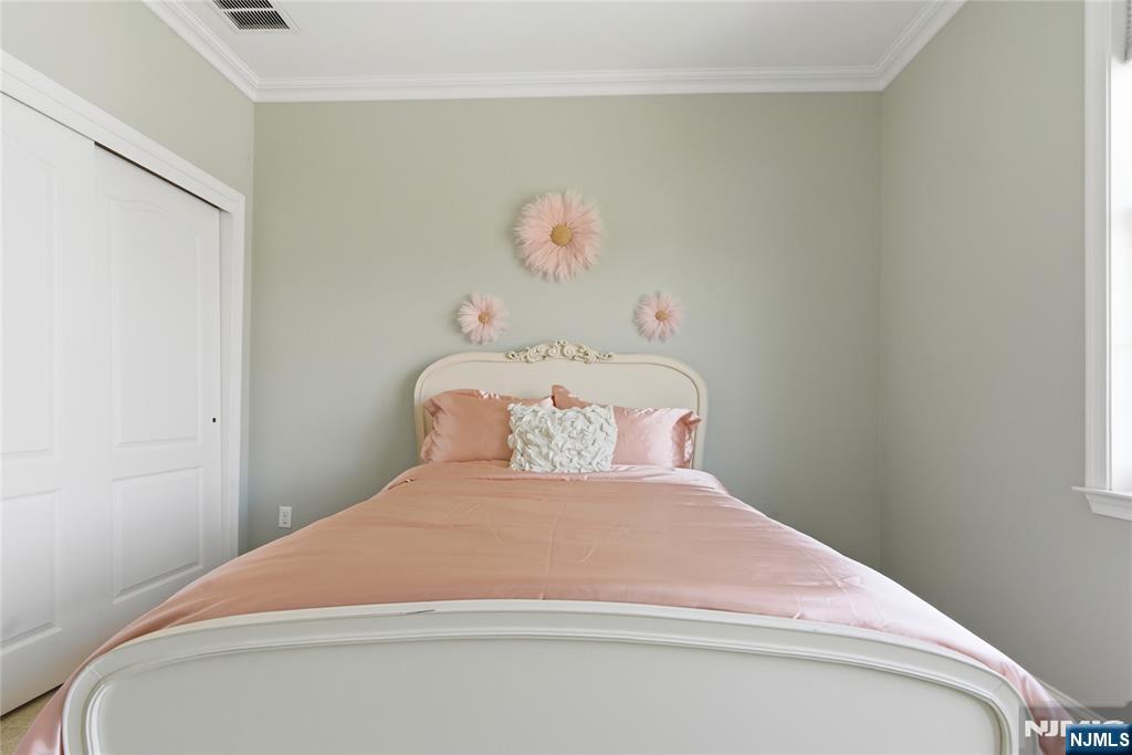 14 Gable Walk Livingston, NJ 07039 - Photo 27 of 41 a bedroom with a bed and a painting on the wall