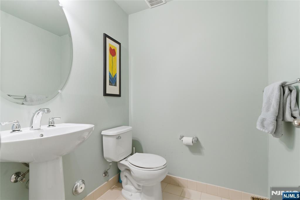 14 Gable Walk Livingston, NJ 07039 - Photo 35 of 41 a bathroom with a toilet sink and mirror