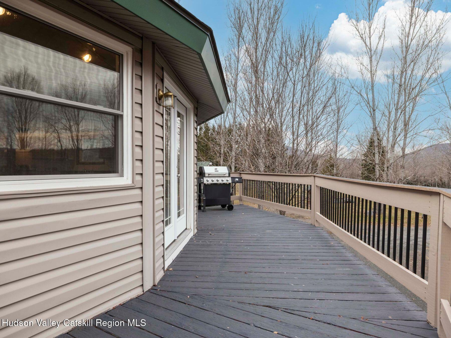 215 Siam Road Windham, NY 12496 - Photo 11 of 65 a view of a balcony with wooden floor and fence