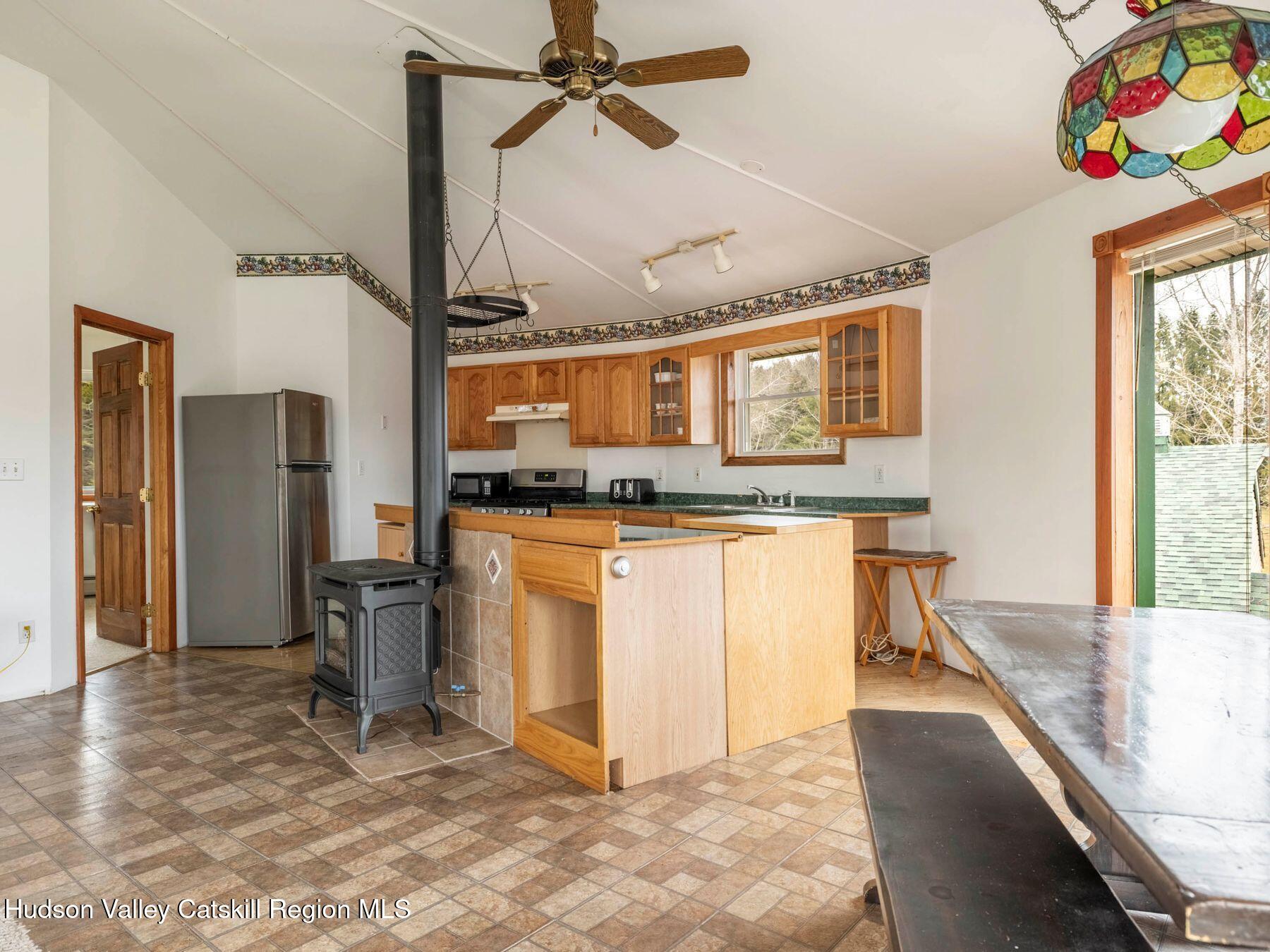 215 Siam Road Windham, NY 12496 - Photo 30 of 65 a kitchen with stainless steel appliances granite countertop a sink a stove a refrigerator and a cabinets