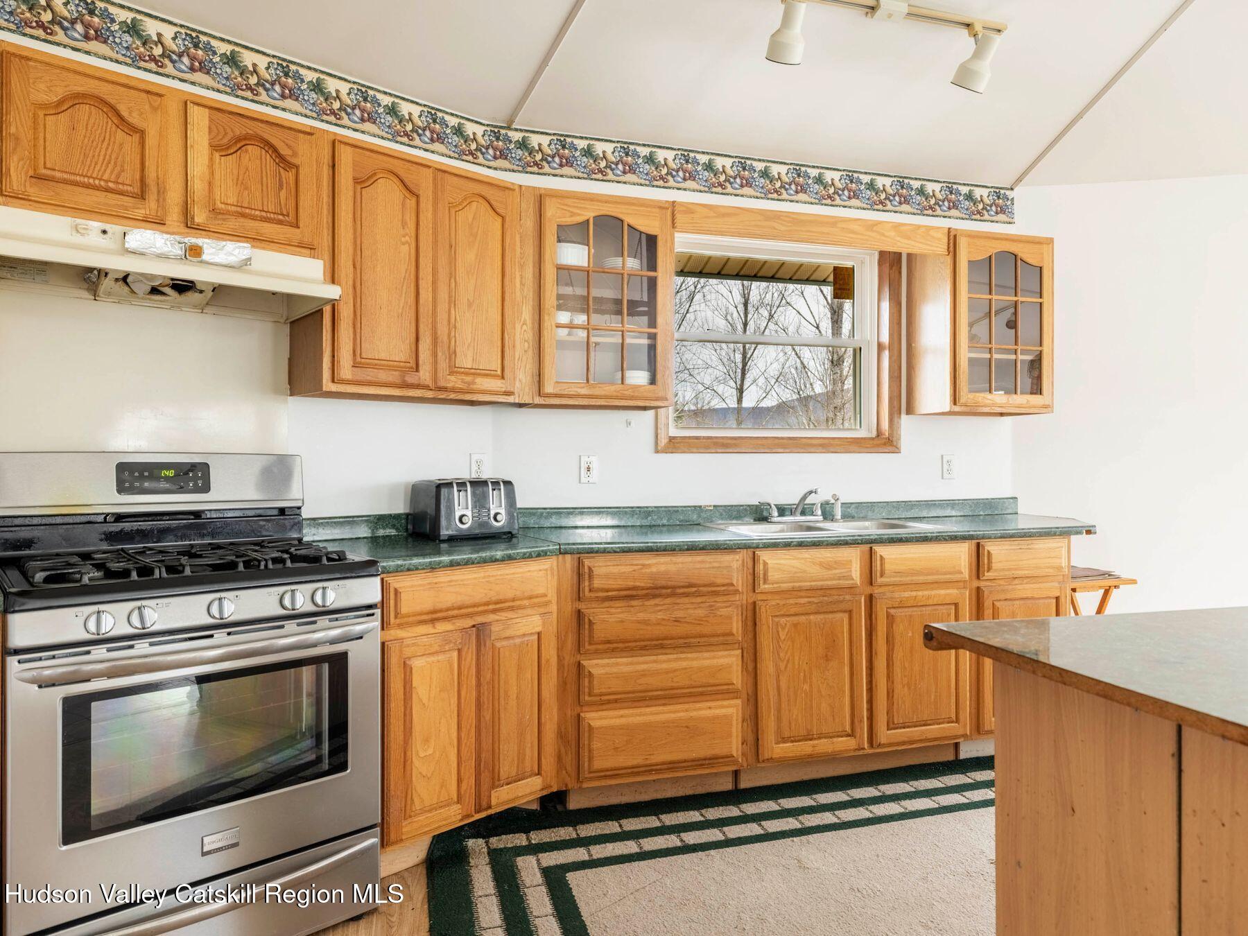 215 Siam Road Windham, NY 12496 - Photo 31 of 65 a kitchen with stainless steel appliances granite countertop a stove and a microwave