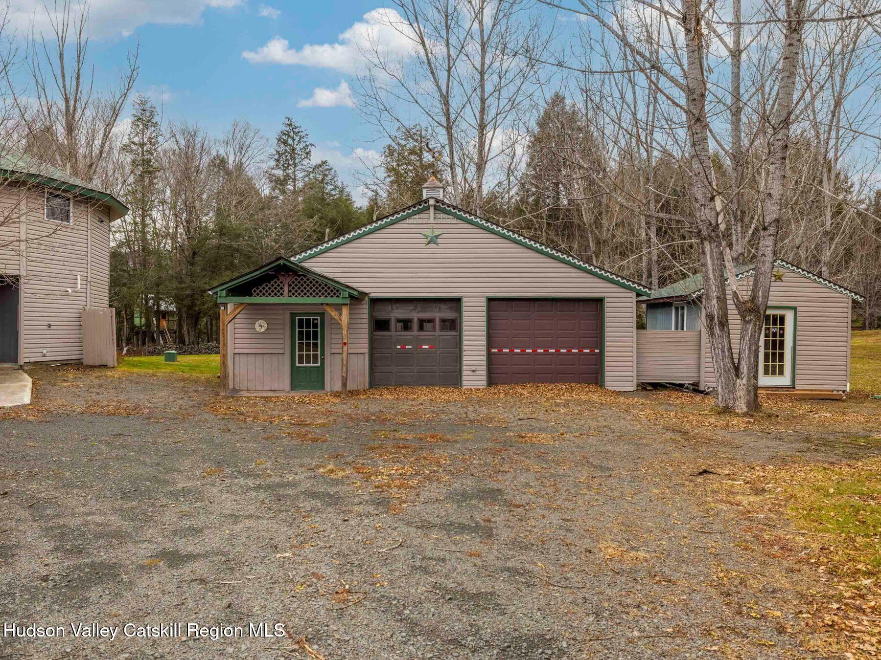 215 Siam Road Windham, NY 12496 - Photo 45 of 65 a front view of a house with a yard and garage