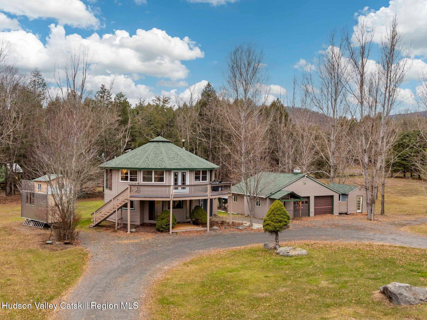 215 Siam Road Windham, NY 12496 - Photo 8 of 65 a front view of a house with a garden and trees