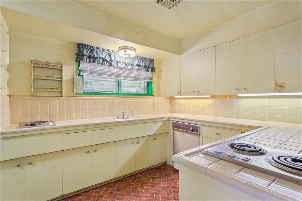 1118 Kane Street Waco, TX 76705 - Photo 11 of 32 a kitchen with a sink cabinets and a window