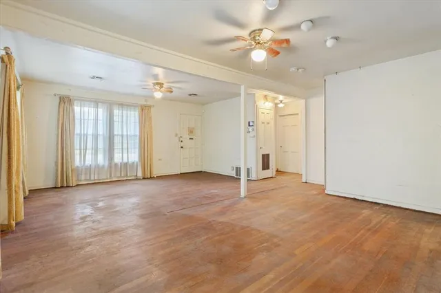 wooden floor in an empty room with a window