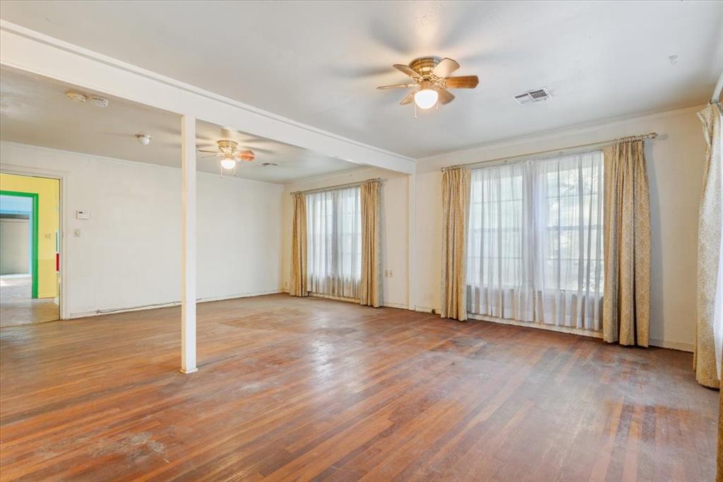 1118 Kane Street Waco, TX 76705 - Photo 6 of 32 an empty room with wooden floor and windows