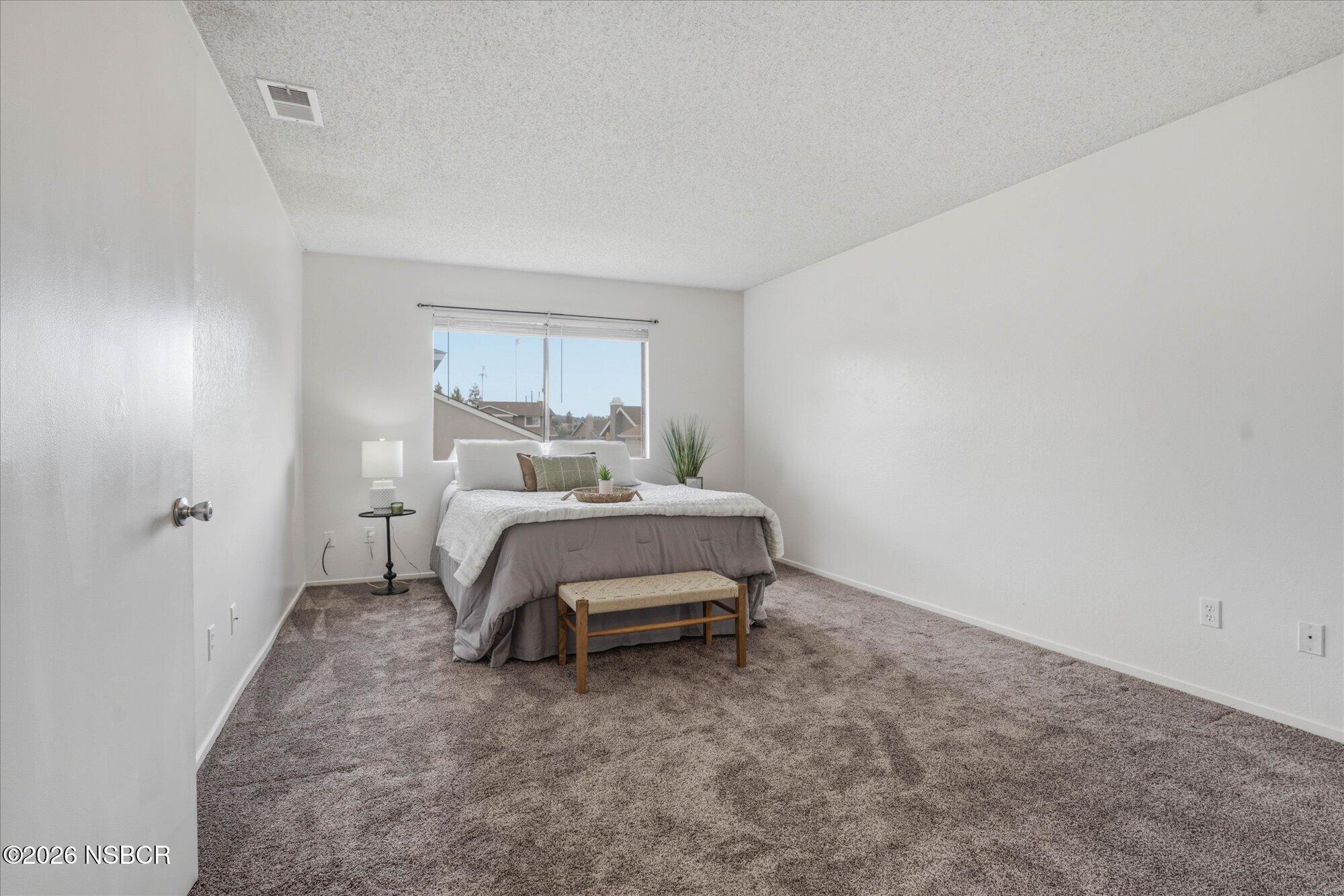 1192 Sumner Place, Unit D Santa Maria, CA 93455 - Photo 10 of 18 a bedroom with a bed and a window