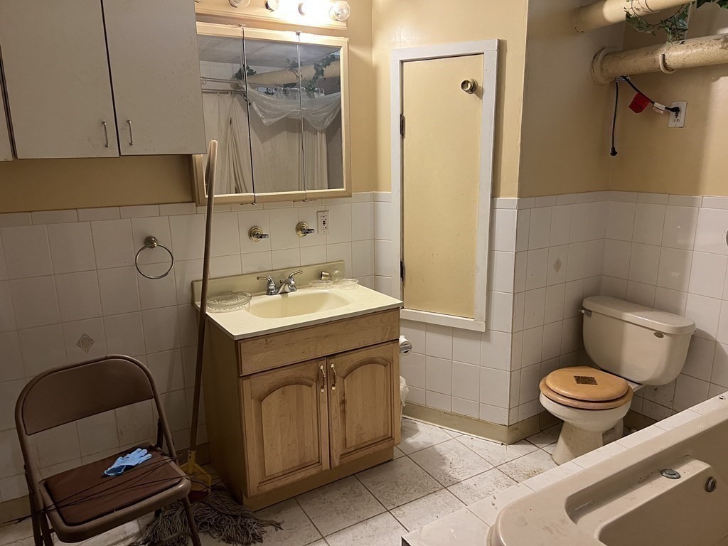 90 Forbes Street Boston, MA 02130 - Photo 19 of 22 a bathroom with a sink toilet and mirror