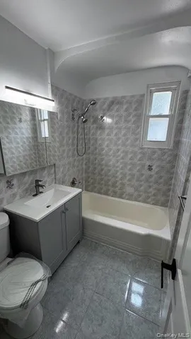 a bathroom with a sink a toilet and a bathtub