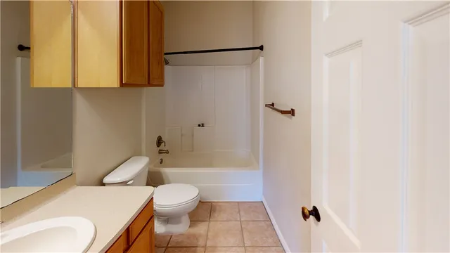 a white toilet sitting next to a bath tub
