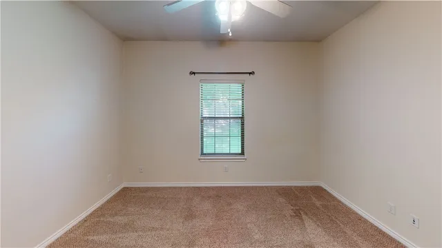 an empty room that has a window in it