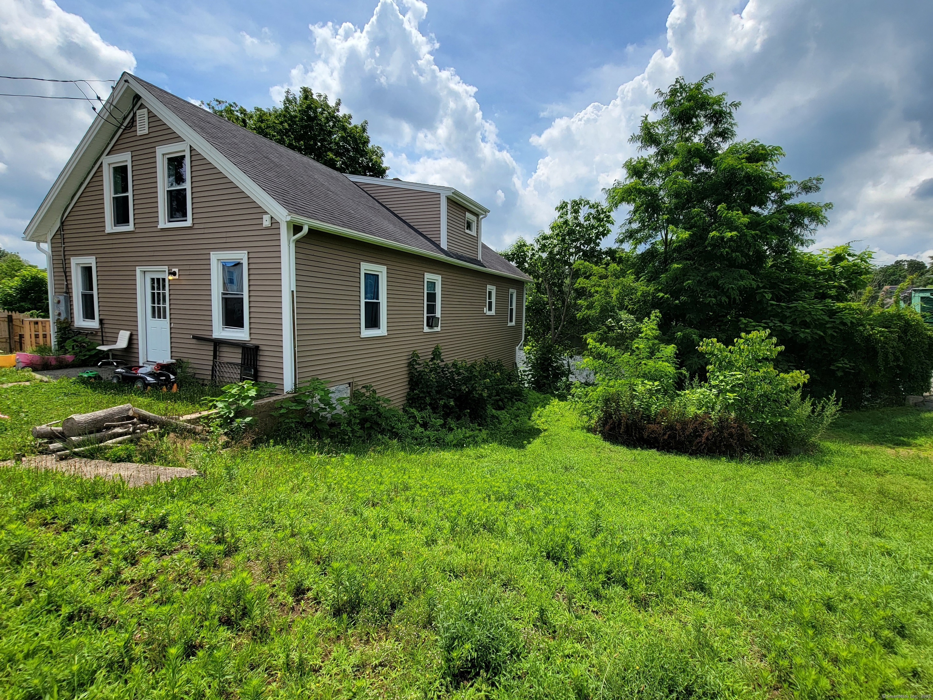a front view of house with yard and green space
