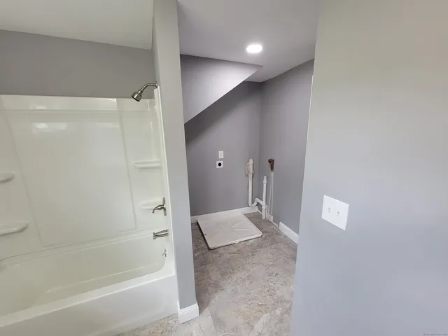 a bathroom with a bathtub and a shower