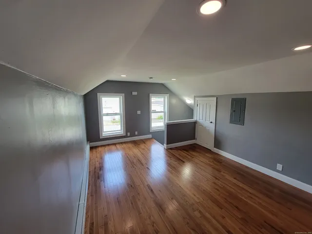 a view of empty room with wooden floor
