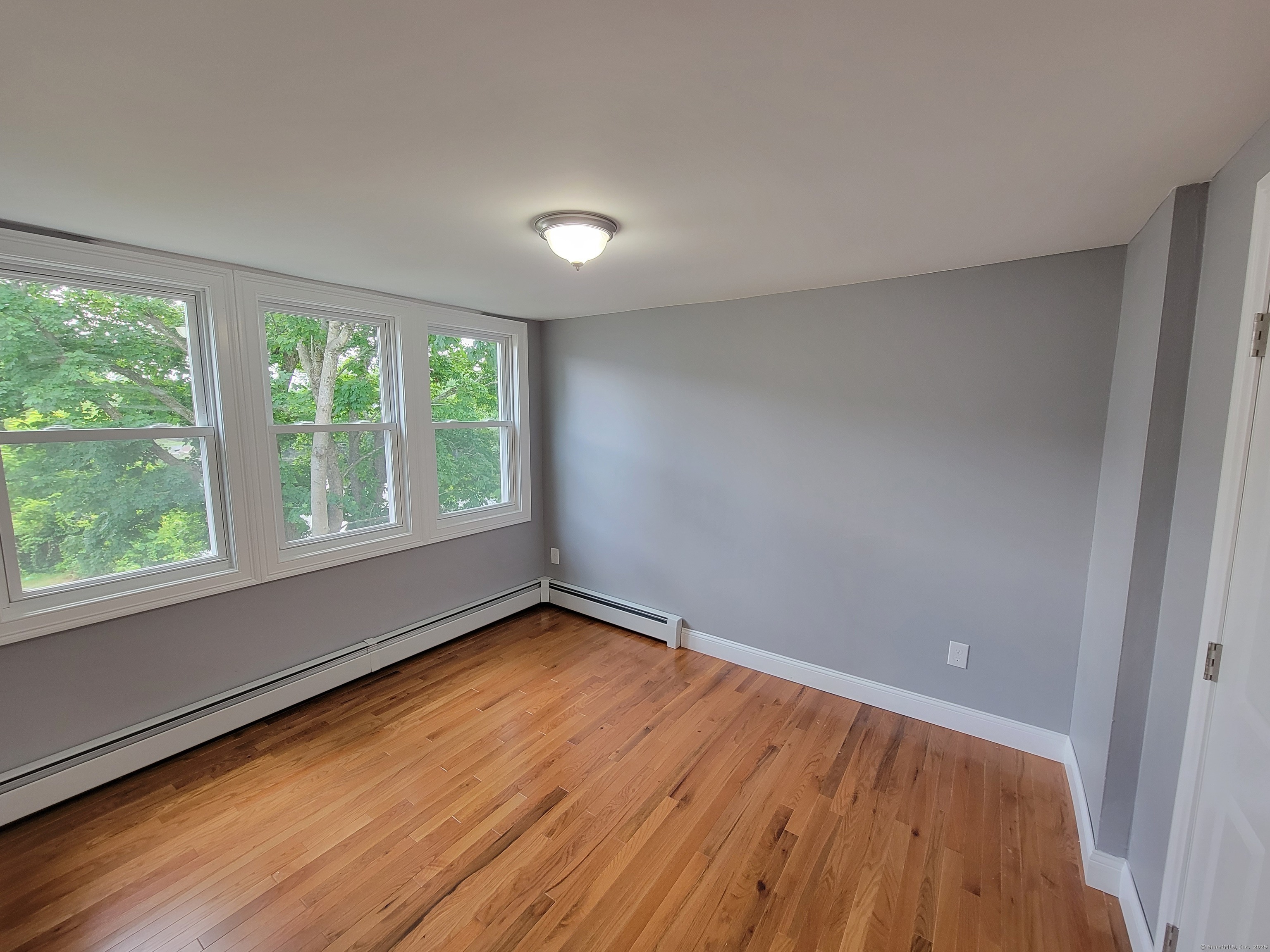 3 Water Street Killingly, CT 06239 - Photo 18 of 38 a view of an empty room with wooden floor and a window