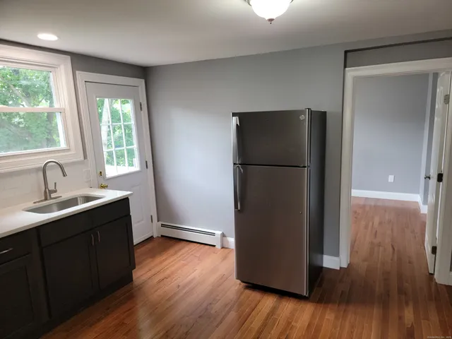 a kitchen with a refrigerator and a sink