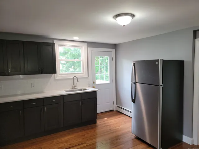 a kitchen with a sink a window and stainless steel appliances