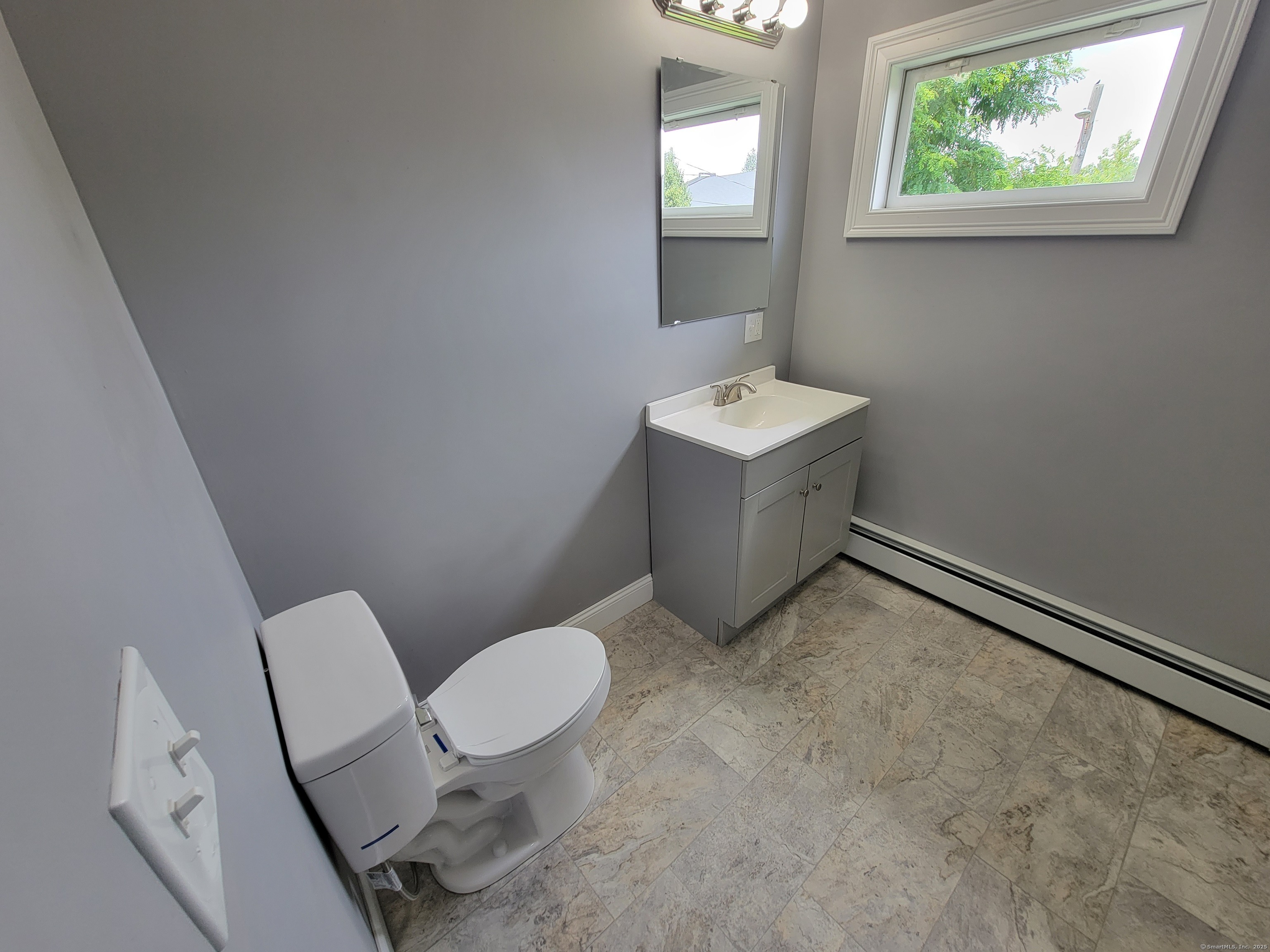 3 Water Street Killingly, CT 06239 - Photo 10 of 38 a bathroom with a toilet sink and mirror