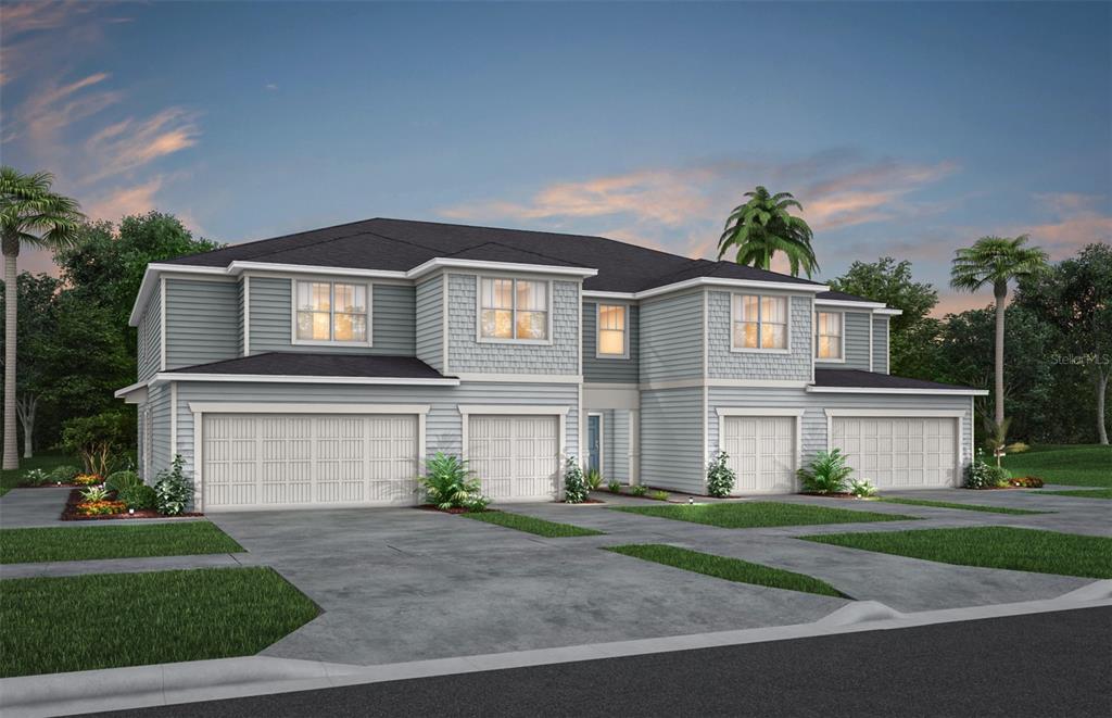 a front view of a house with a yard and a garage