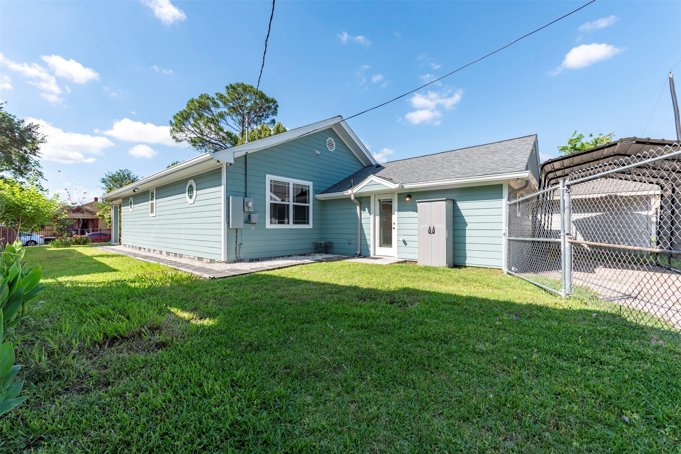 109 Dresden Street Houston, TX 77012 - Photo 38 of 43 This charming home features a well-maintained lawn, and a fenced yard. It has a small storage shed, offering ample outdoor space and privacy.