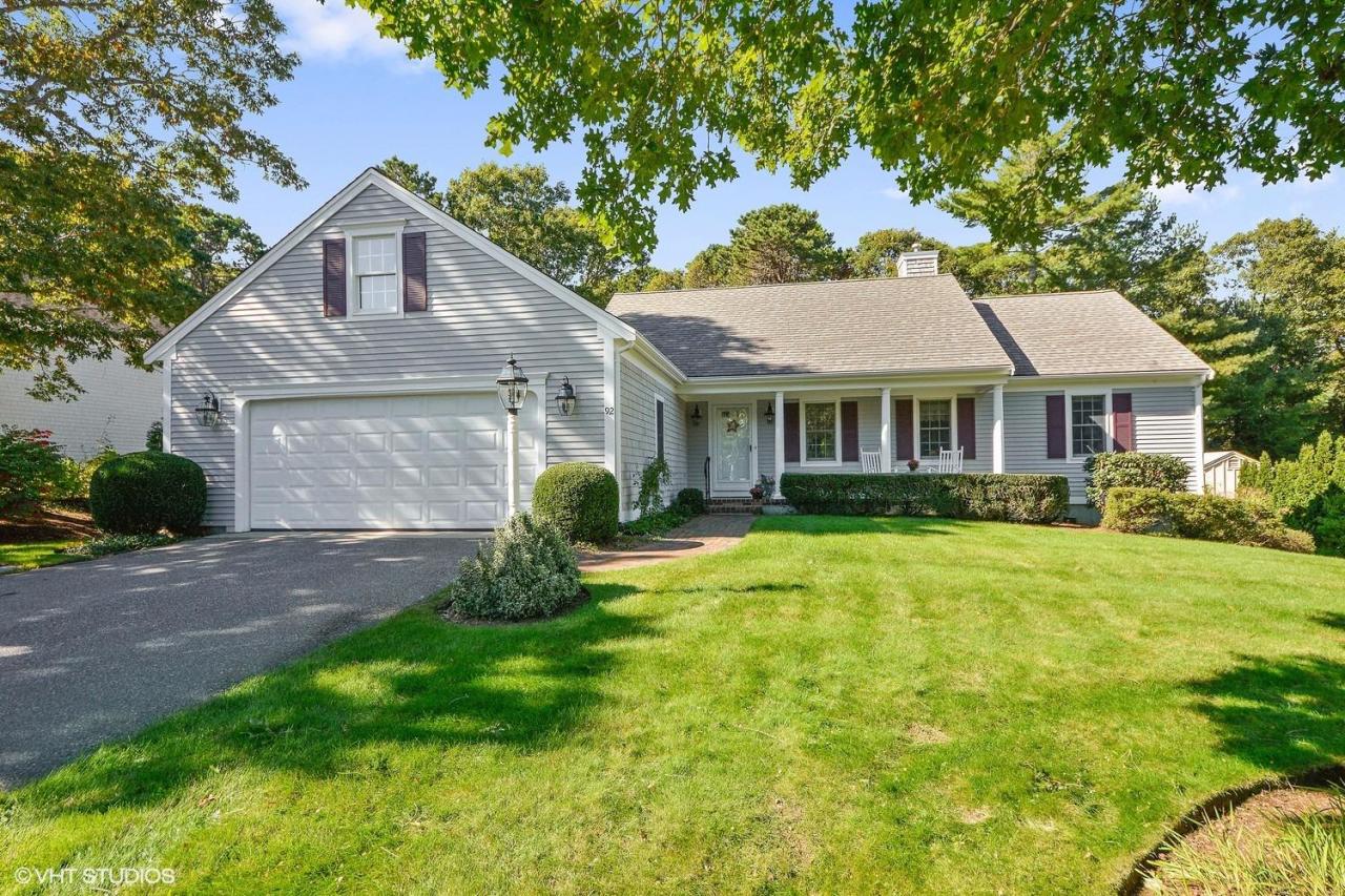 92 Falling Leaf Lane Osterville, MA 02655 - Photo 1 of 15 a front view of a house with a yard and garage
