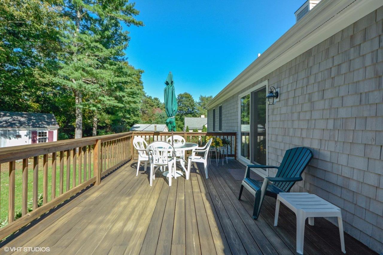92 Falling Leaf Lane Osterville, MA 02655 - Photo 14 of 15 a view of a chairs and table on the deck