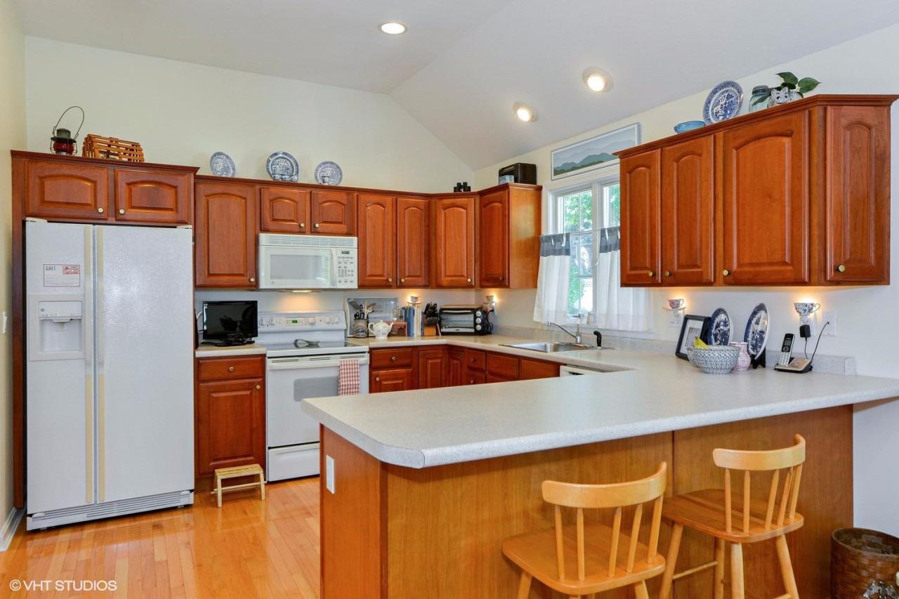 92 Falling Leaf Lane Osterville, MA 02655 - Photo 4 of 15 a kitchen with stainless steel appliances granite countertop a refrigerator and a stove top oven