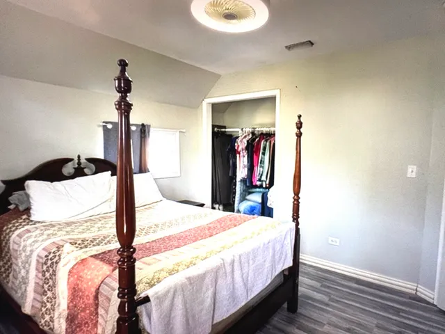 a bedroom with a bed and a mirror