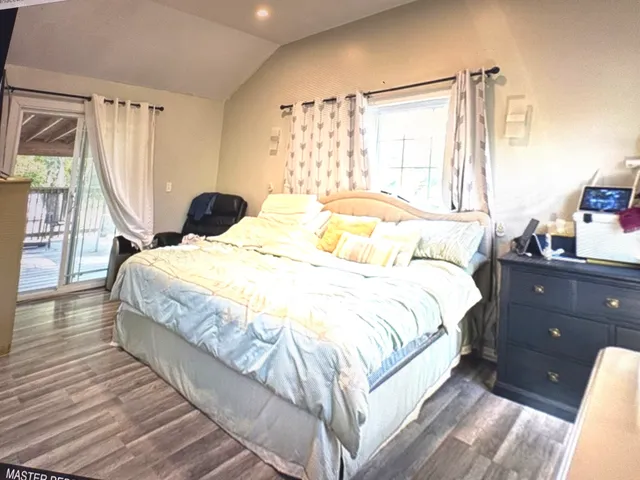 a bed sitting in a bedroom next to a window