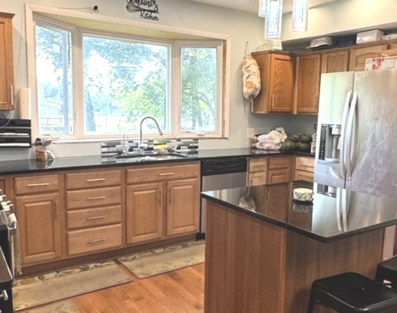 307 Mills Road Joliet, IL 60433 - Photo 5 of 22 a kitchen with stainless steel appliances granite countertop a sink a stove and a refrigerator