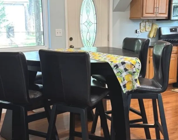a view of a dining room with furniture and a large window
