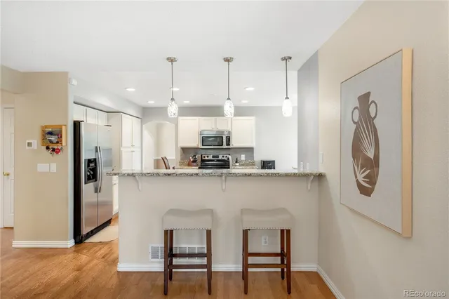 a kitchen with a sink cabinets and wooden floor
