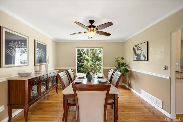 a kitchen with stainless steel appliances granite countertop a sink a stove a refrigerator and island with wooden floor