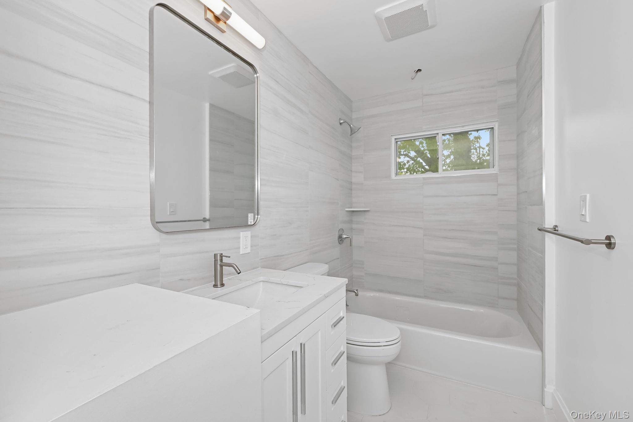 24 Country Road Mamaroneck, NY 10543 - Photo 24 of 37 a bathroom with a sink a toilet and shower