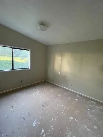 a bathroom with a granite countertop sink a toilet and a mirror