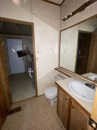 a kitchen with granite countertop a sink stove and cabinets