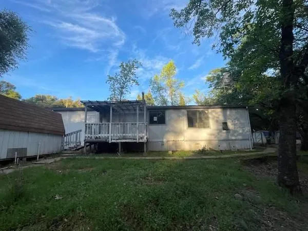 a view of a back yard of the house with a yard