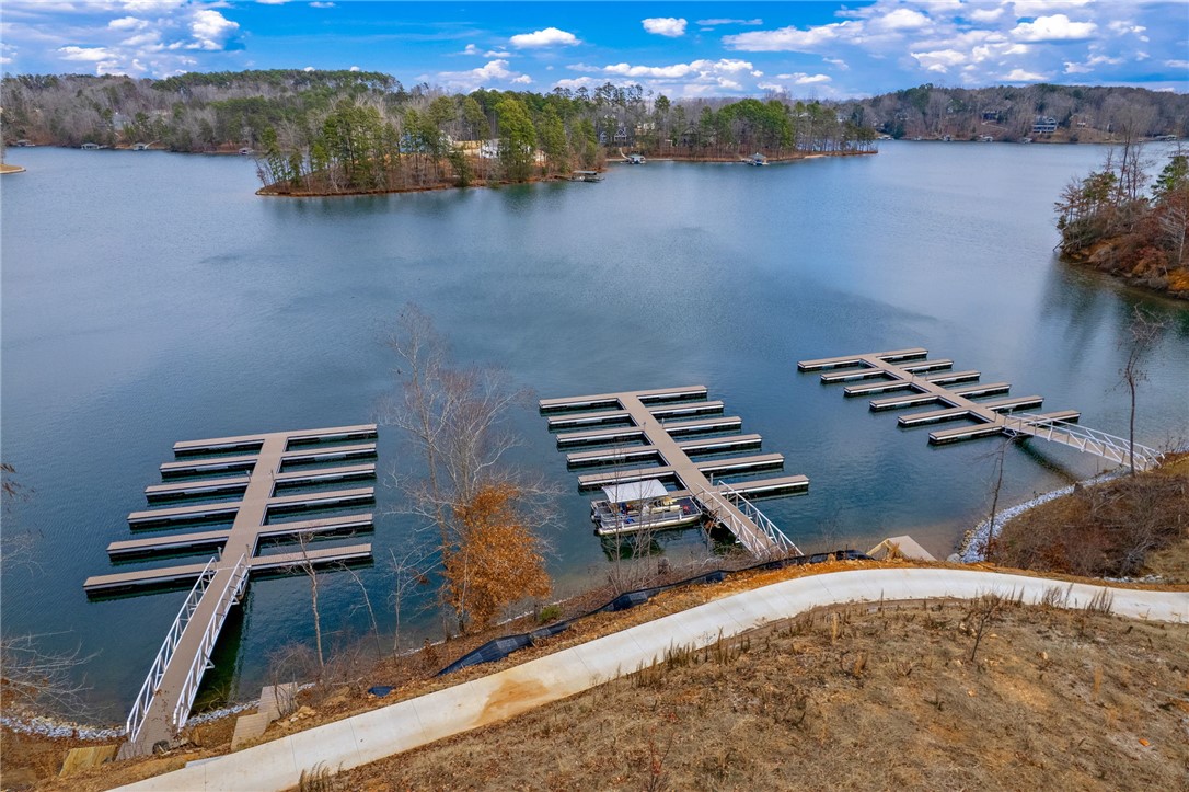 1230 Melton Road, Unit 215 West Union, SC 29696 - Photo 48 of 50 This serene waterfront property features multiple boat docks on a clear lake surrounded by lush trees.