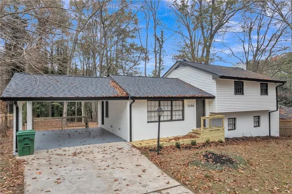 a house that has a tree in front of it