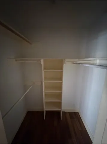 a view of walk in closet with empty racks